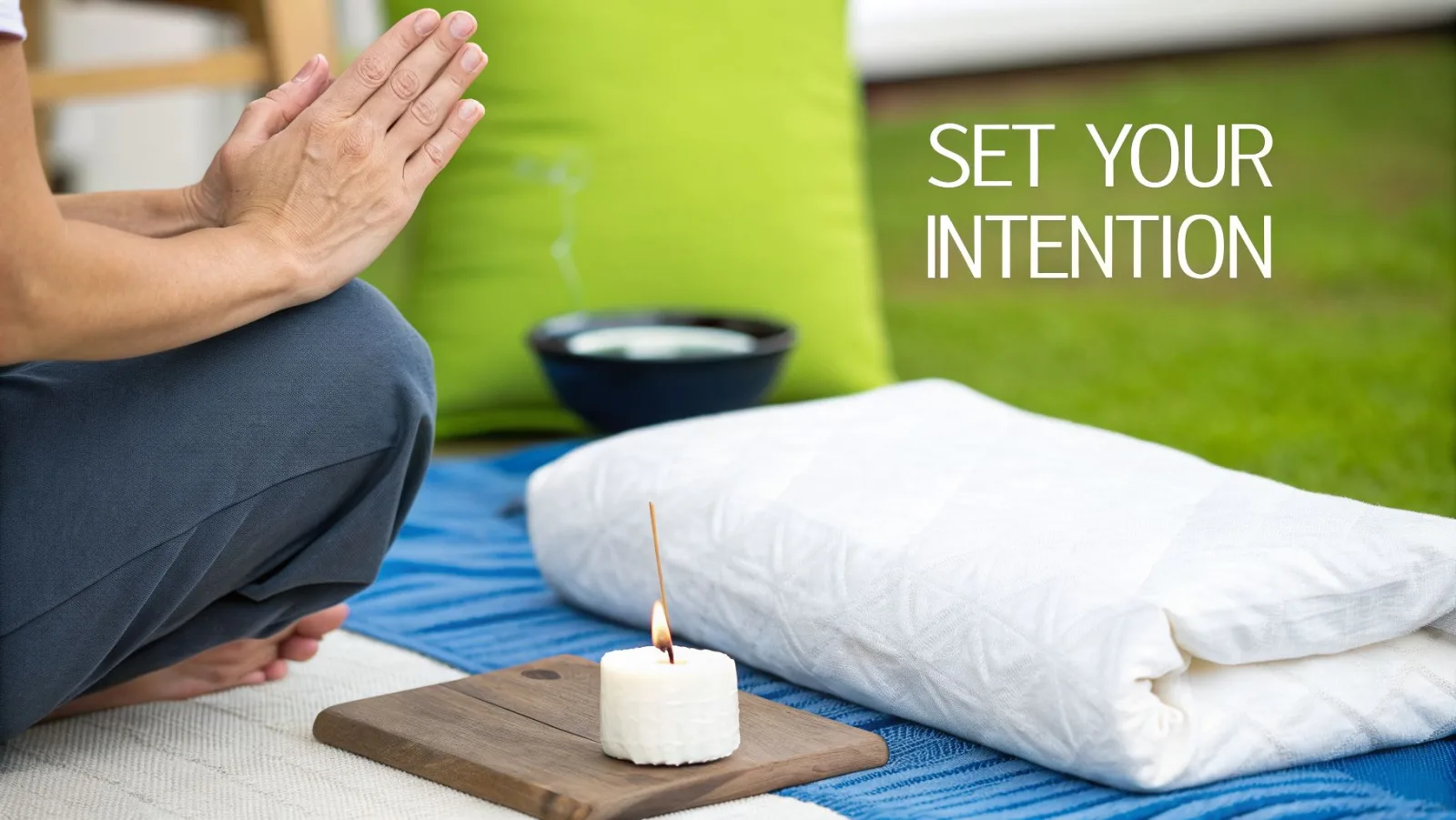 A person meditates outdoors with hands in prayer position, surrounded by spiritual items and text 'SET YOUR INTENTION'.